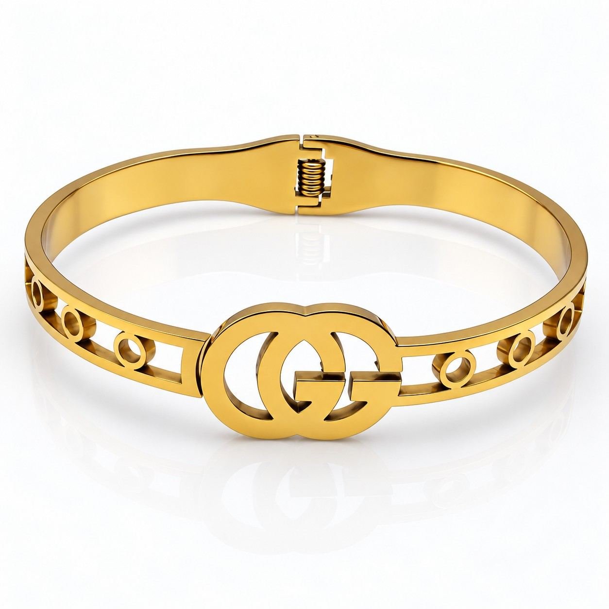 Gold statement bangle with double-circle centerpiece and polished finish. Double-G Bangle Showcase