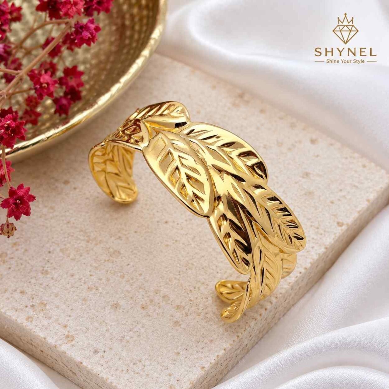 Aurelia leaf weave gold cuff bracelet featuring intricate botanical design.accents and open cuff design.