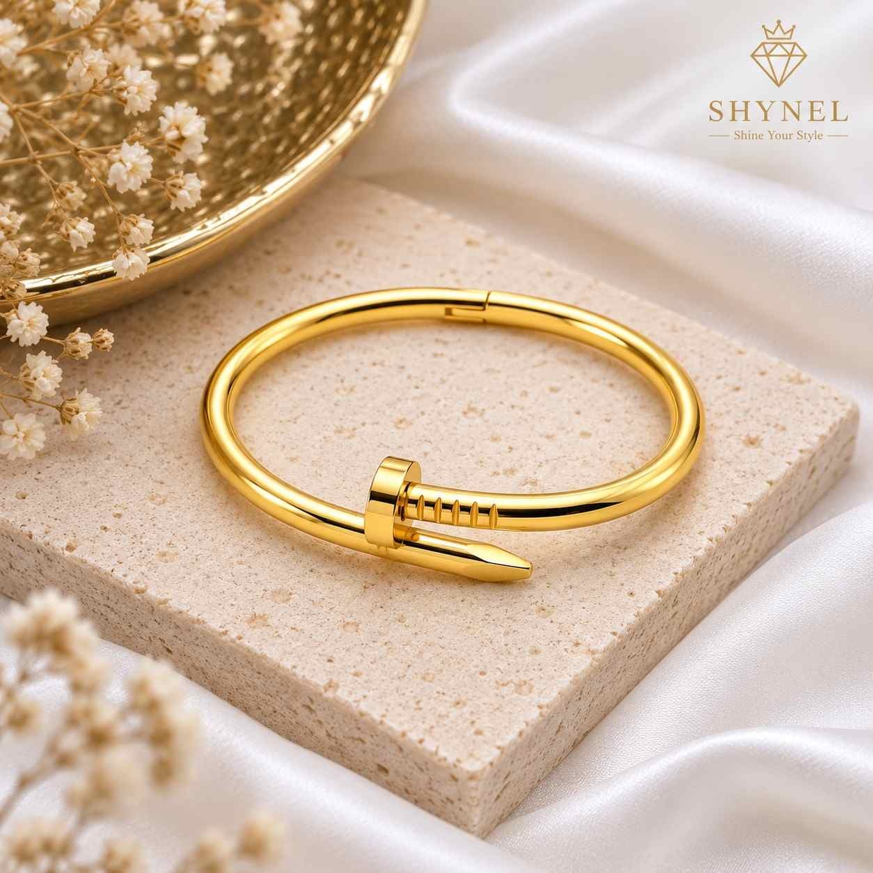 SHYNEL nail inspired gold bangle bracelet with polished finish for women on white background